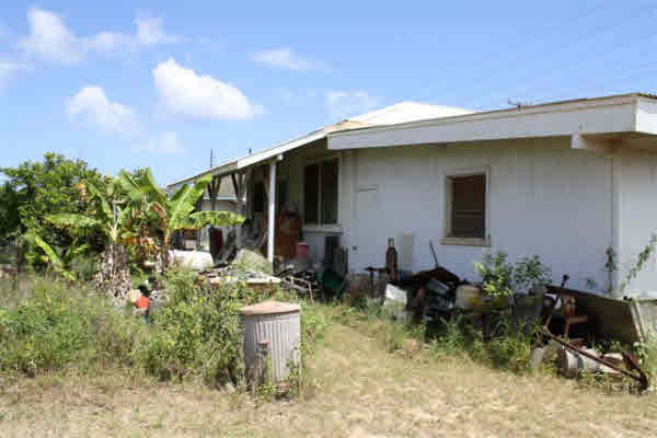 8399 Elepaio Road Kekaha, HI 96752 - Photo 7 of 8 a front view of a house with garden