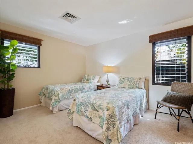 a bedroom with two beds and a couch