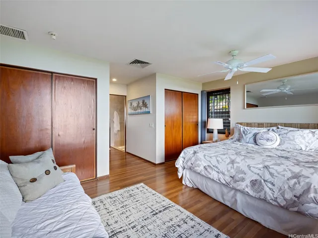 a bedroom with a large bed and a chandelier