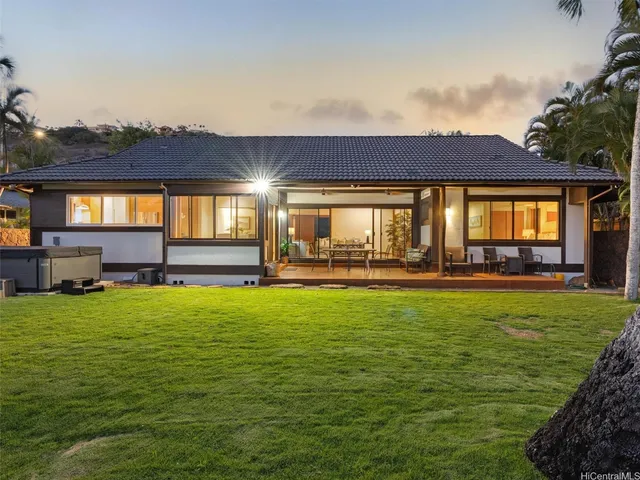a swimming pool with outdoor seating and yard