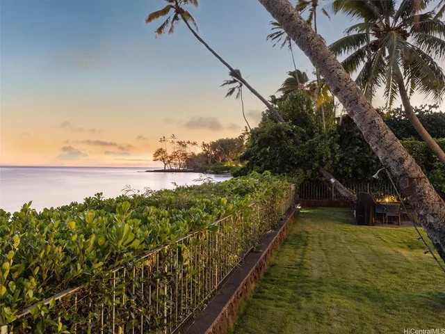 a white cabinet with a vase of flowers on it