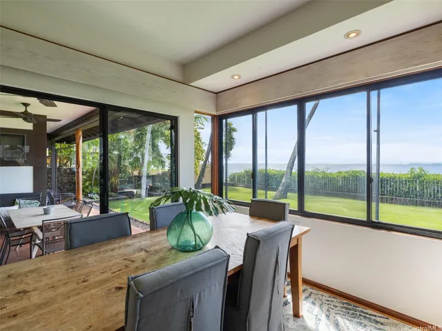 a living room with furniture and floor to ceiling windows