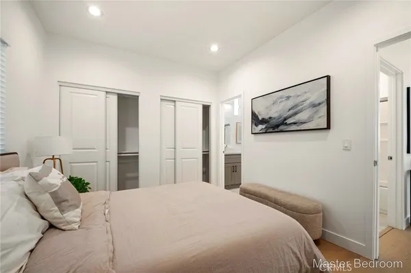 a bedroom with a bed and a painting on the wall