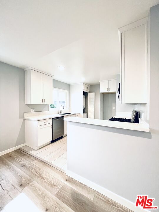 1116 San Rafael Avenue, Unit 1 Glendale, CA 91202 - Photo 14 of 33 a kitchen with stainless steel appliances white cabinets and a refrigerator