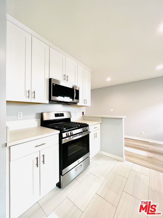 1116 San Rafael Avenue, Unit 1 Glendale, CA 91202 - Photo 16 of 33 a kitchen with white cabinets and appliances