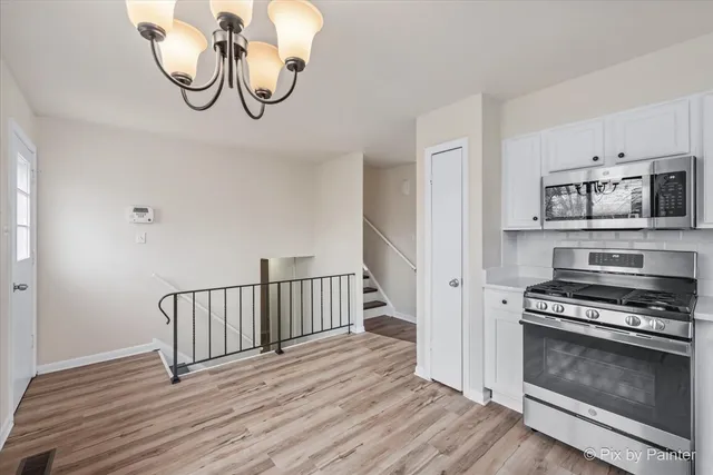 a view of a room with wooden floor