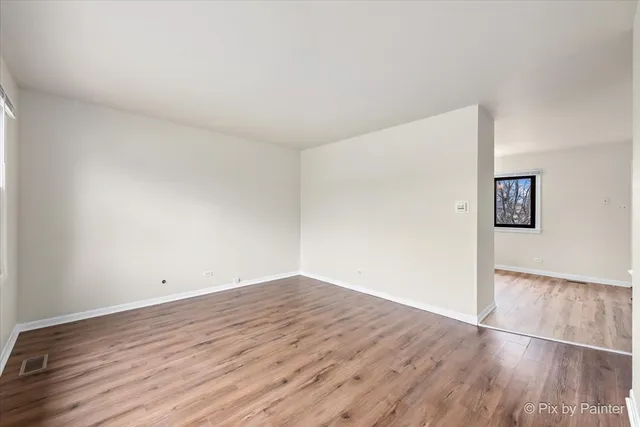 a view of a room with wooden floor