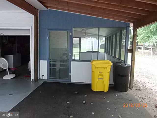 8434 Maryland Road Pasadena, MD 21122 - Photo 16 of 19 patio and screened porch on side