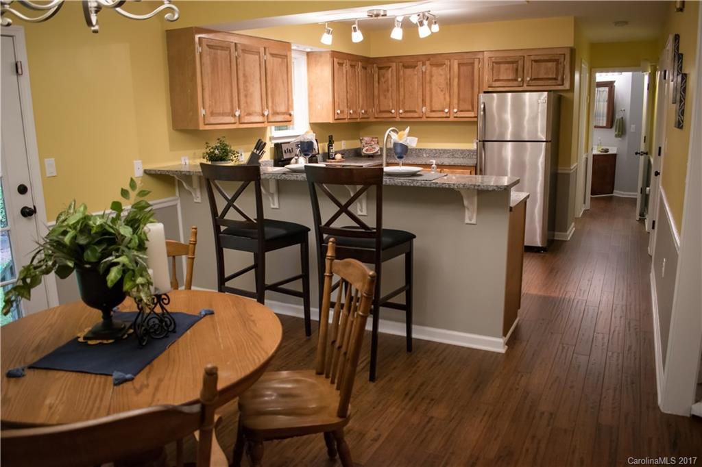 9205 Ladson Road Indian Land, SC 29707 - Photo 5 of 16 a view of a dining room with furniture and wooden floor