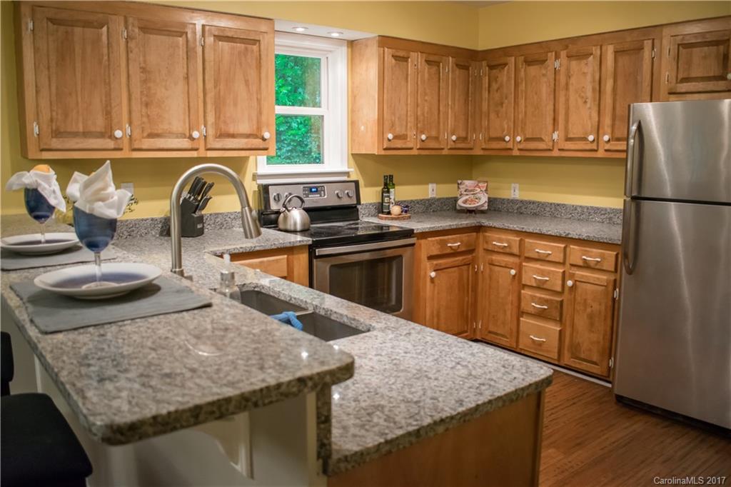9205 Ladson Road Indian Land, SC 29707 - Photo 6 of 16 a kitchen with stainless steel appliances granite countertop a sink stove and refrigerator
