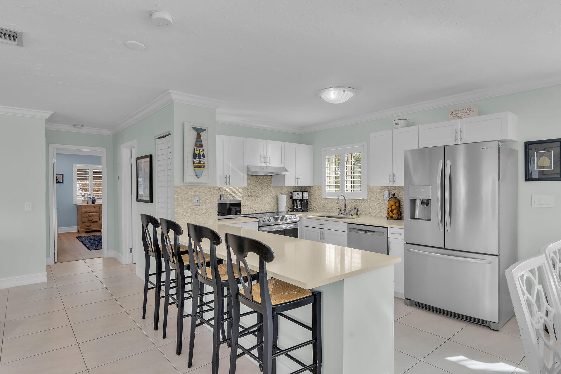 341 Sombrero Beach Road Marathon, FL 33050 - Photo 30 of 44 a kitchen with a dining table chairs refrigerator and cabinets
