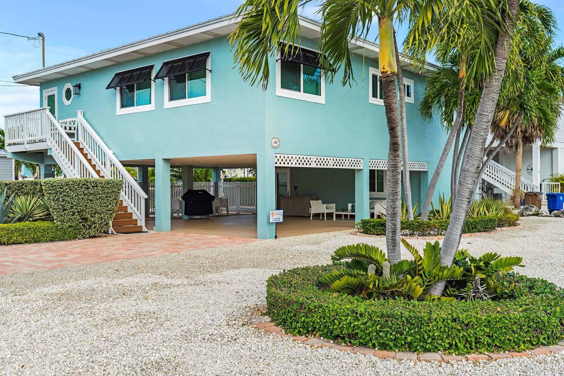 341 Sombrero Beach Road Marathon, FL 33050 - Photo 4 of 44 a front view of a house with garden
