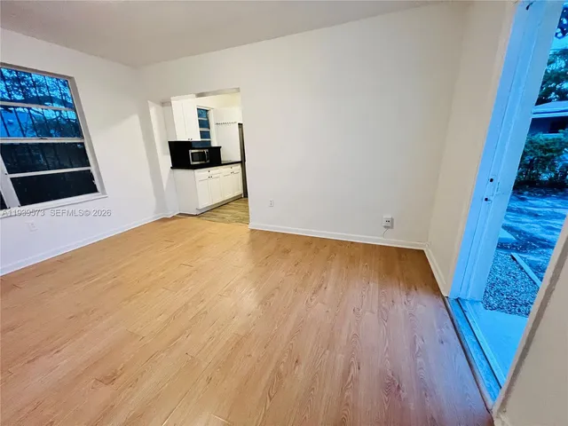 a view of a sink and wooden floor in a room