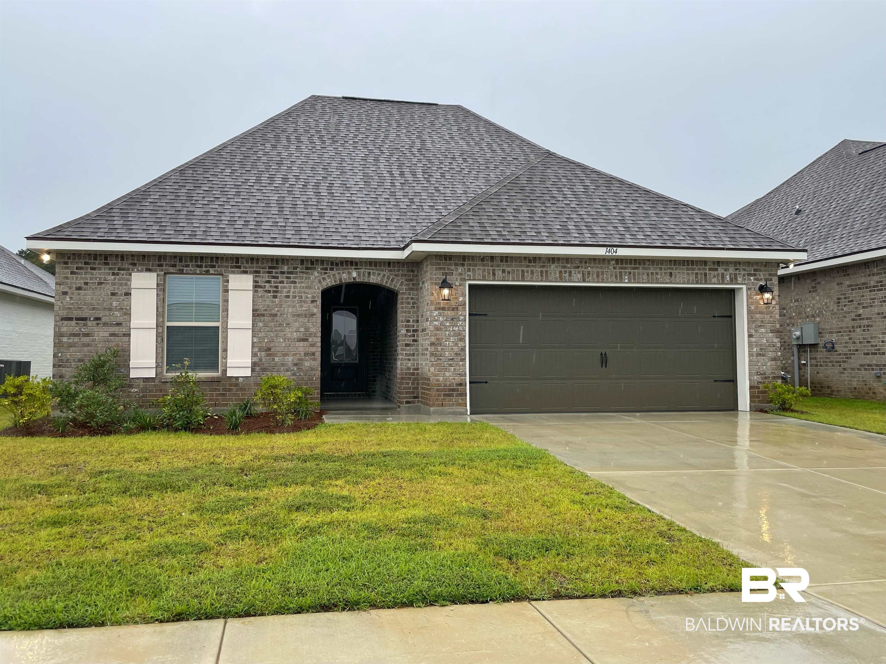 1404 Fenton Circle Foley, AL 36535 - Photo 1 of 3 View of front facade featuring a garage and a front lawn