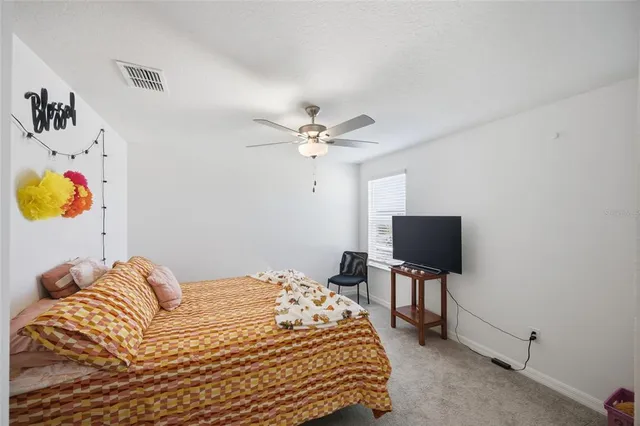 a bedroom with a bed and flat screen tv