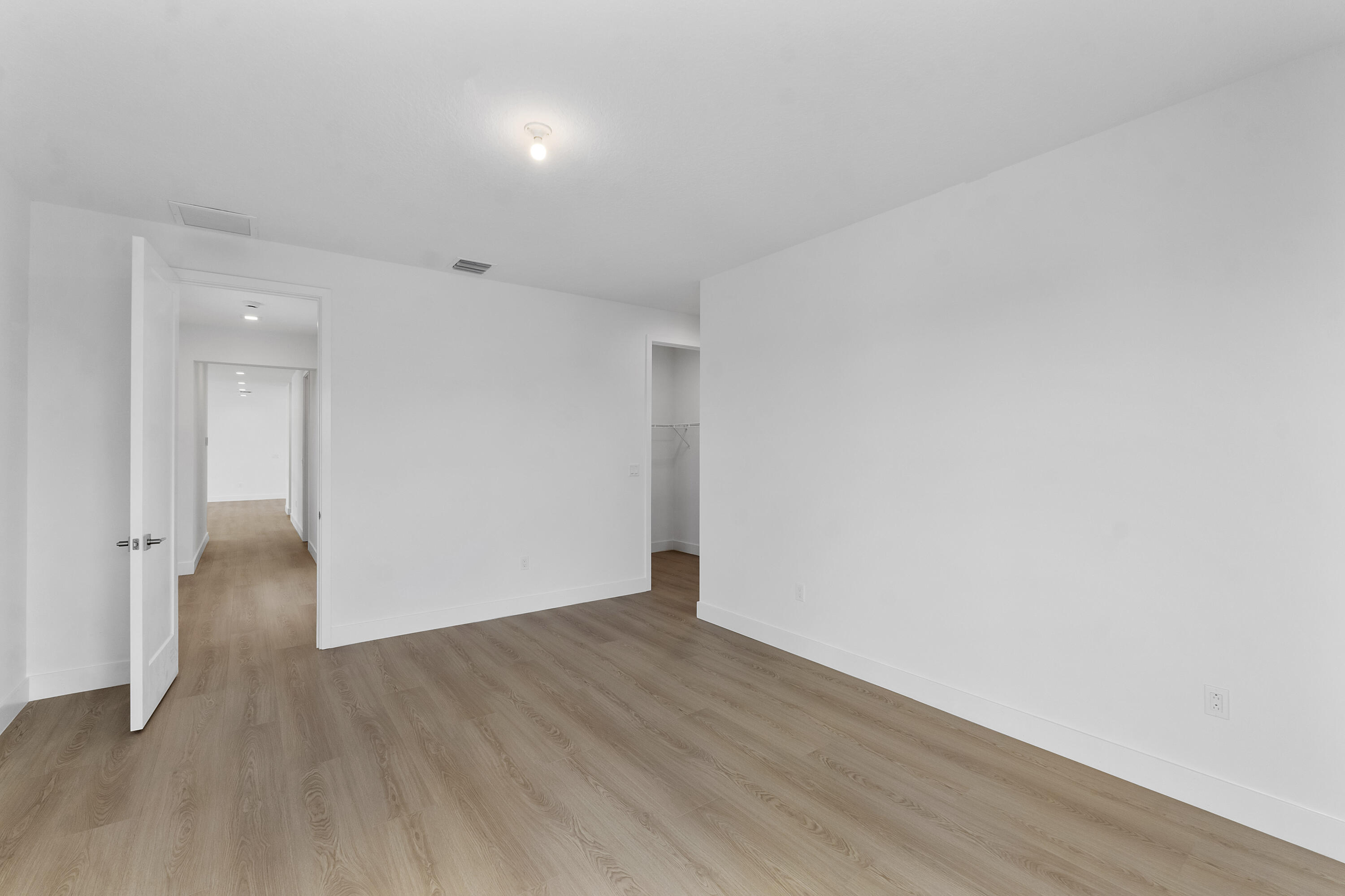9322 Sunflower Mdw Road Boca Raton, FL 33434 - Photo 44 of 87 a view of an empty room with wooden floor and a window