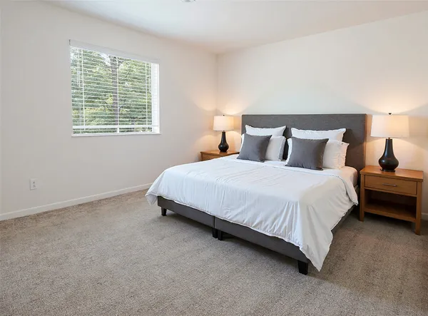 a bedroom with bed and a window