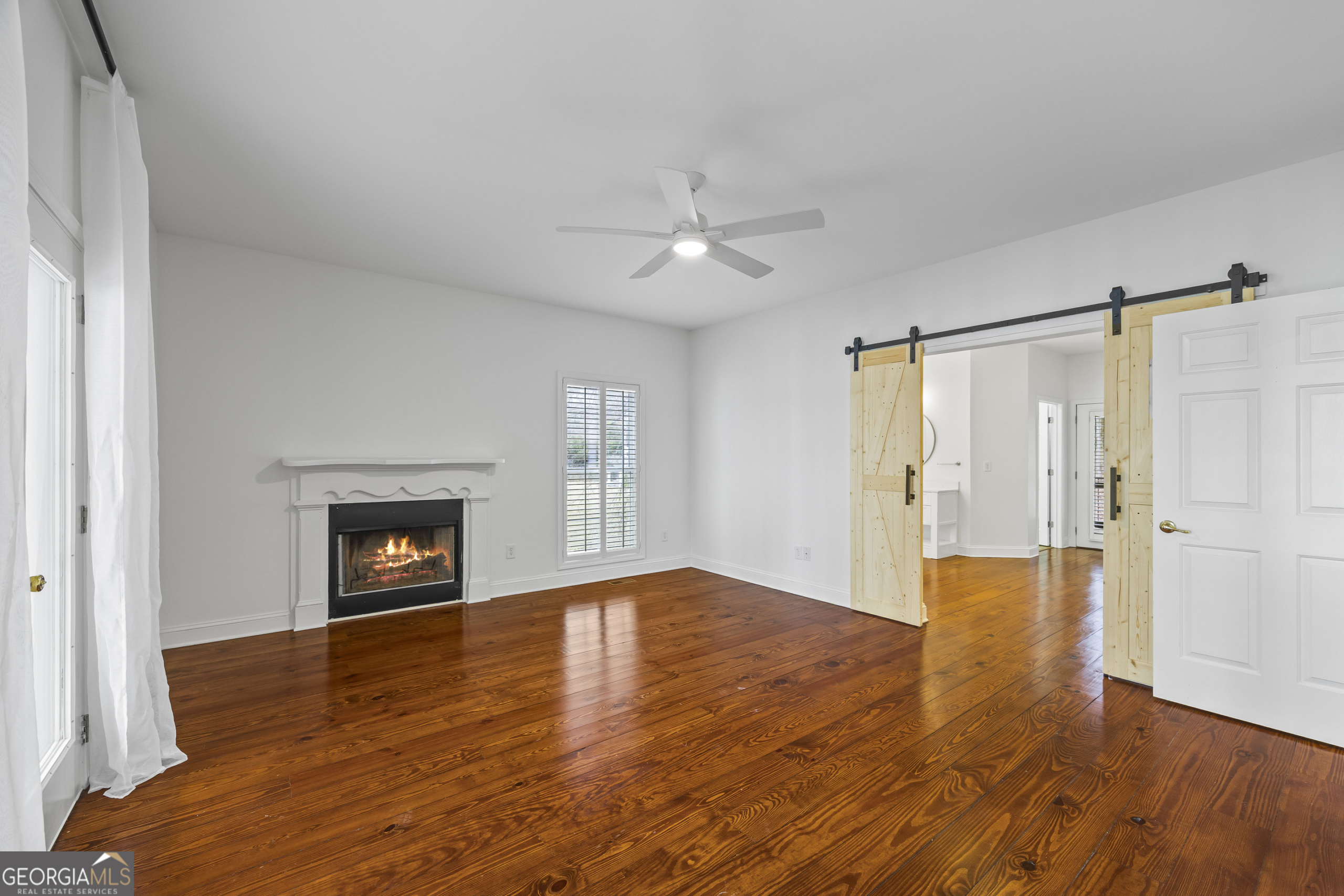 1270 Swords Road Greensboro, GA 30642 - Photo 14 of 41 a view of an empty room with window and wooden floor