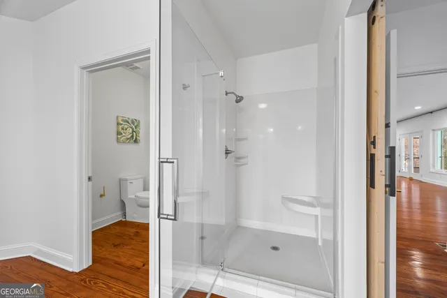 a bathroom with a glass shower door and a sink
