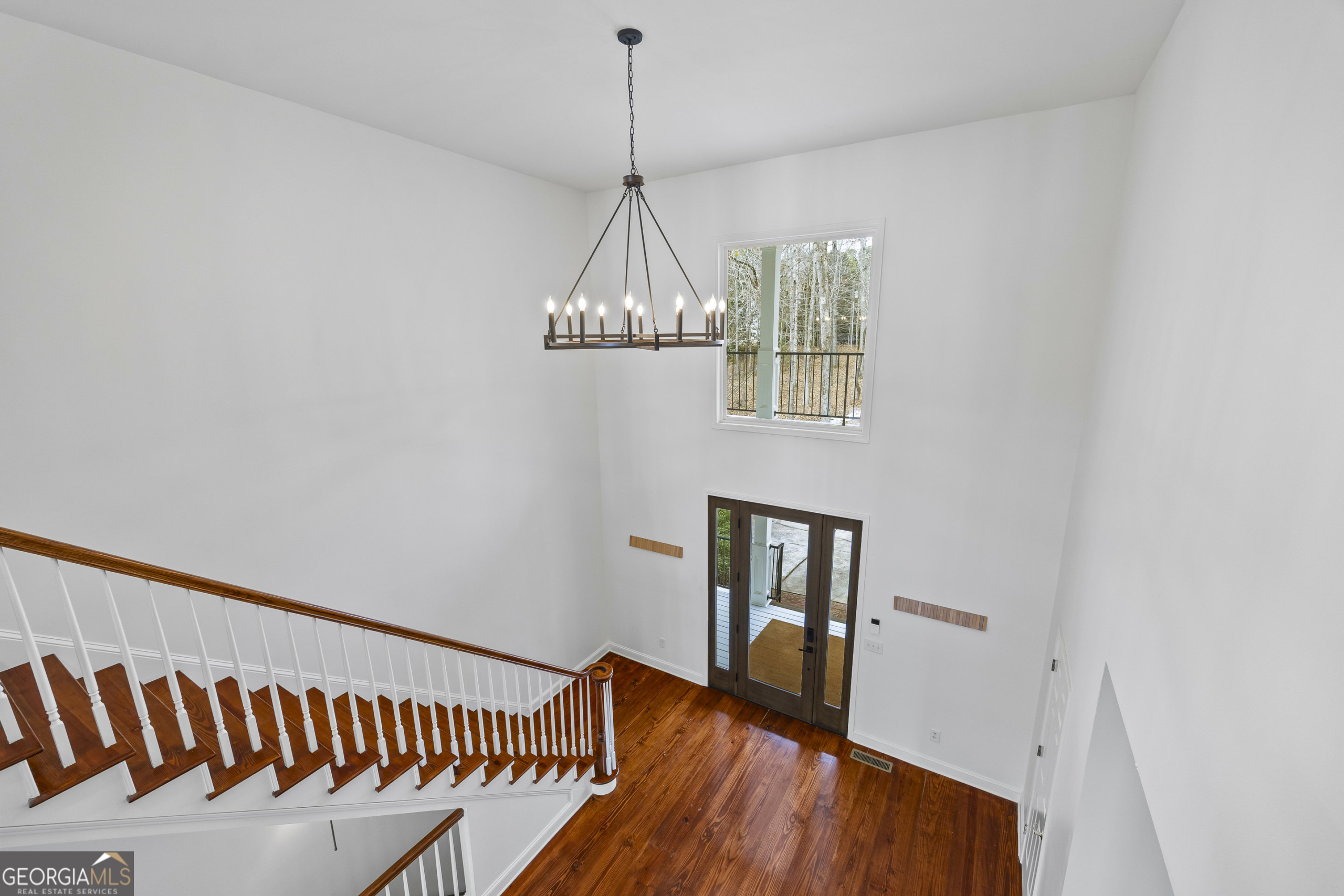 1270 Swords Road Greensboro, GA 30642 - Photo 17 of 41 a view of a hallway with wooden floor and chandelier