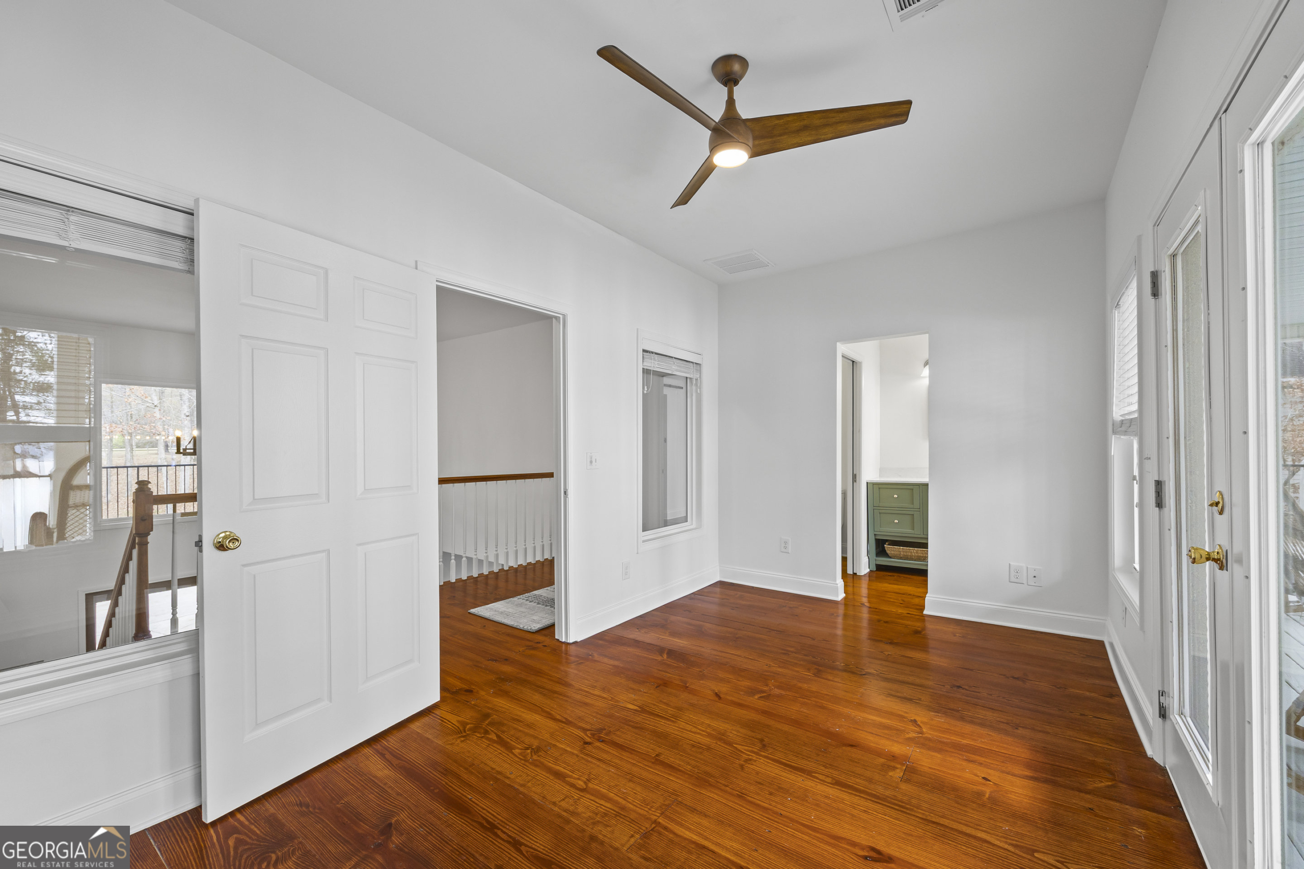 1270 Swords Road Greensboro, GA 30642 - Photo 22 of 41 a view of empty room with wooden floor and fan