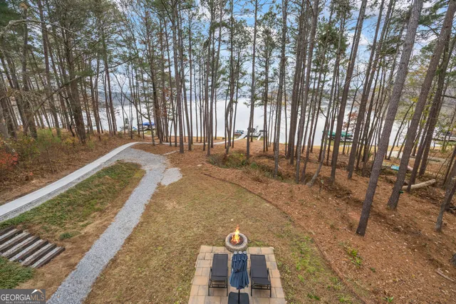 a view of a backyard with large trees