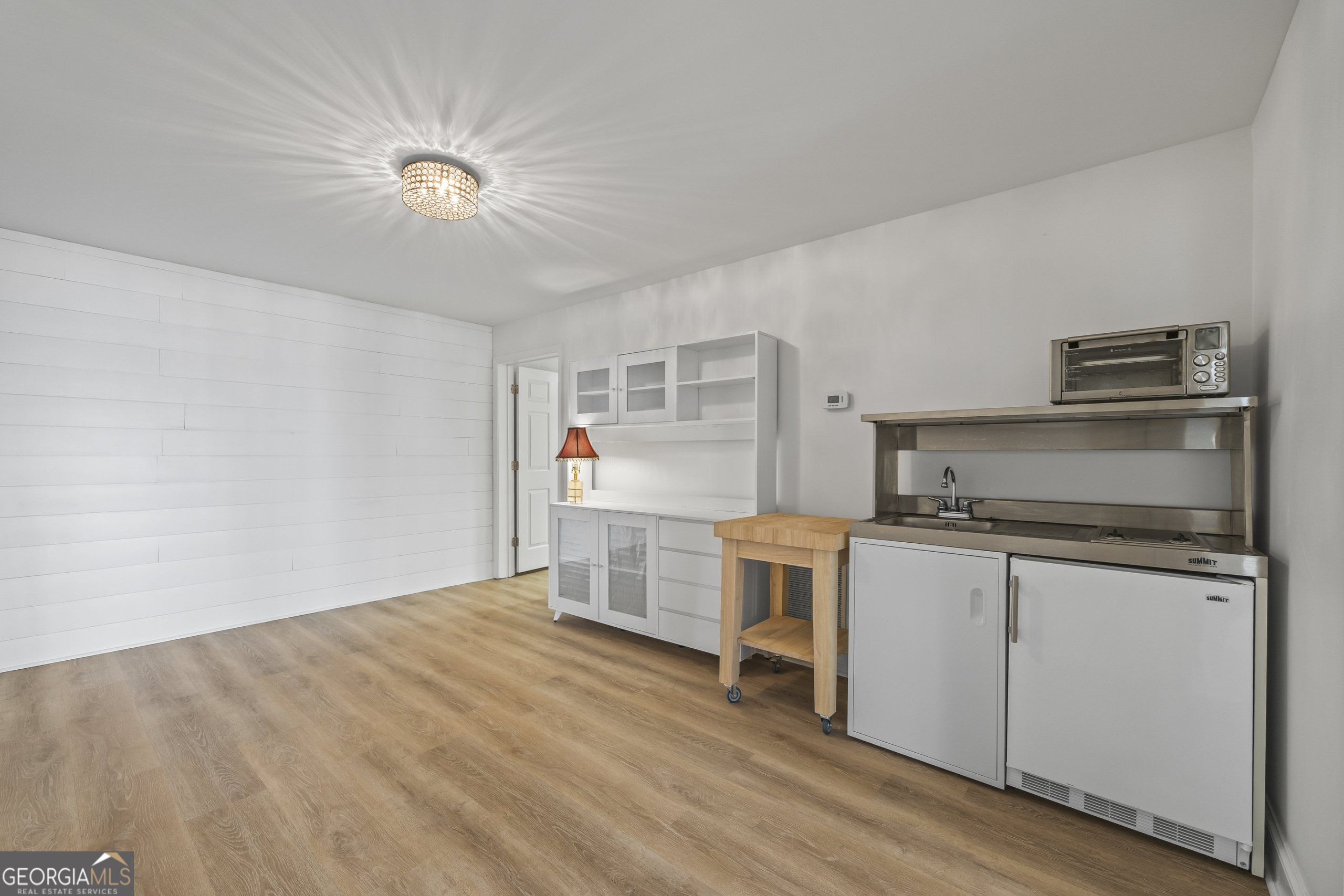 1270 Swords Road Greensboro, GA 30642 - Photo 29 of 41 a kitchen with a refrigerator and white cabinets