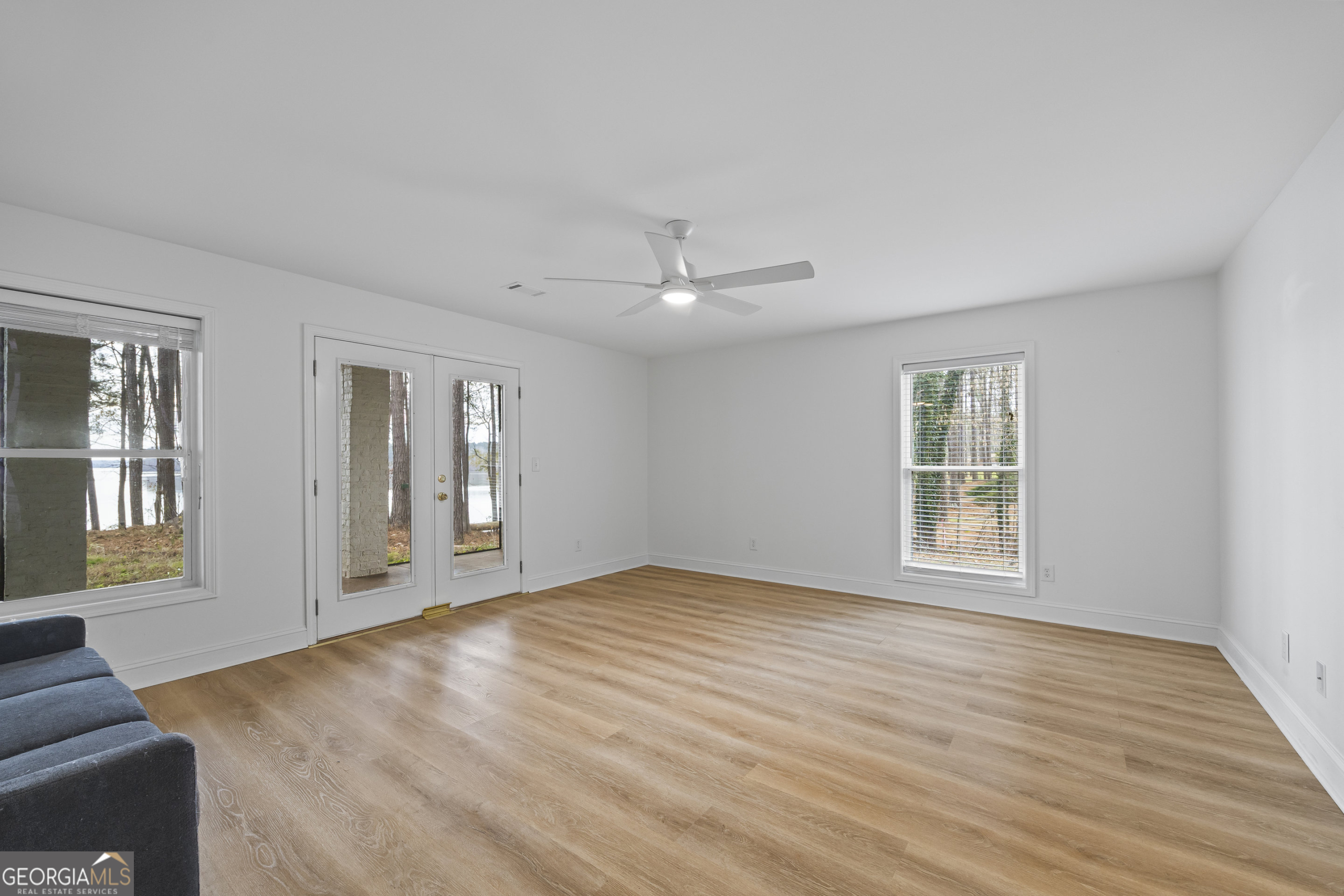 1270 Swords Road Greensboro, GA 30642 - Photo 31 of 41 a view of an empty room with wooden floor and a window