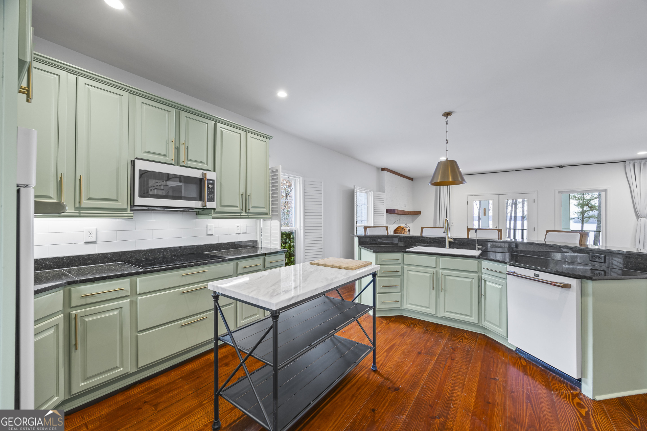 1270 Swords Road Greensboro, GA 30642 - Photo 8 of 41 a kitchen with stainless steel appliances granite countertop a sink and a stove