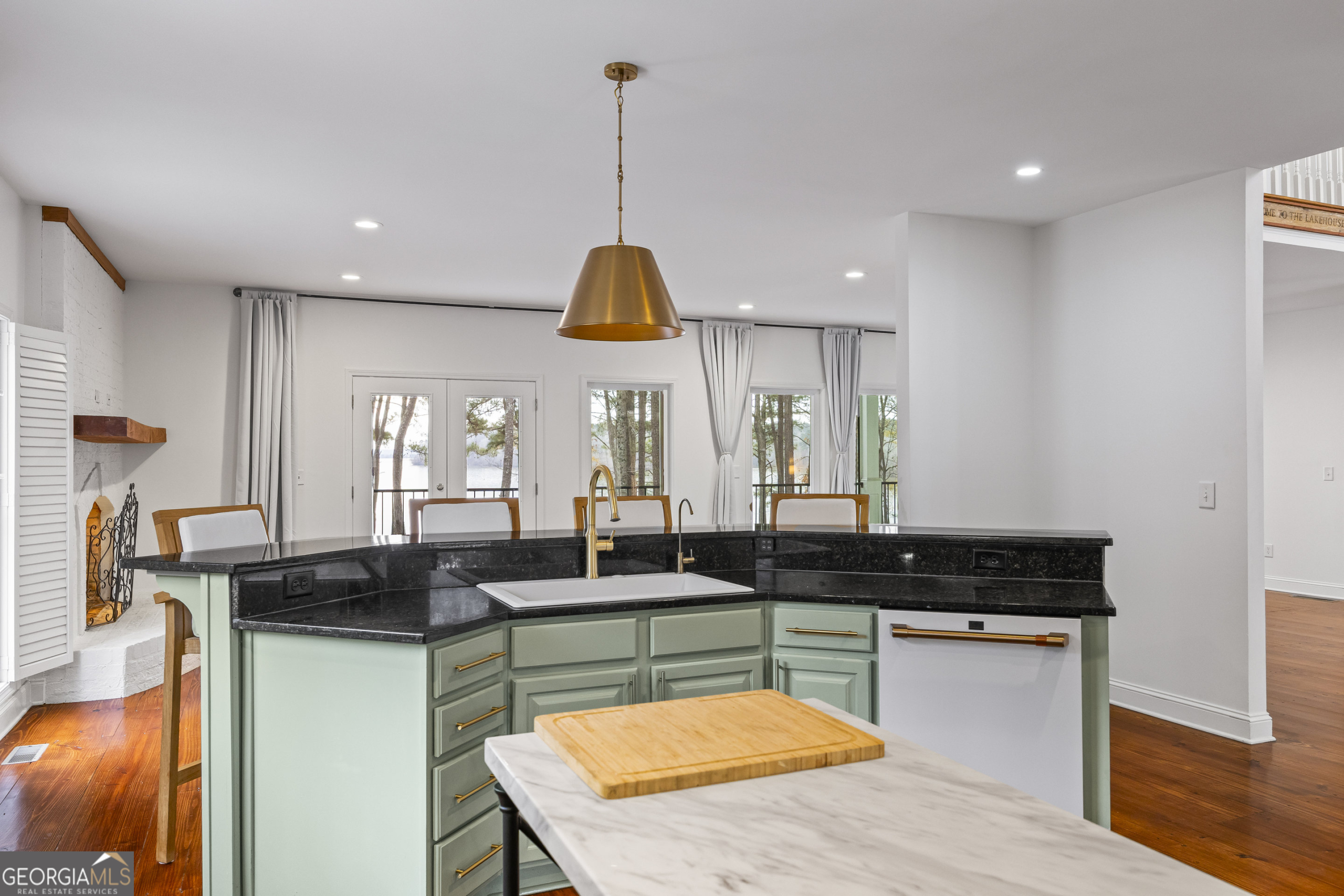 1270 Swords Road Greensboro, GA 30642 - Photo 10 of 41 a kitchen with stainless steel appliances granite countertop a sink a stove and a wooden floors