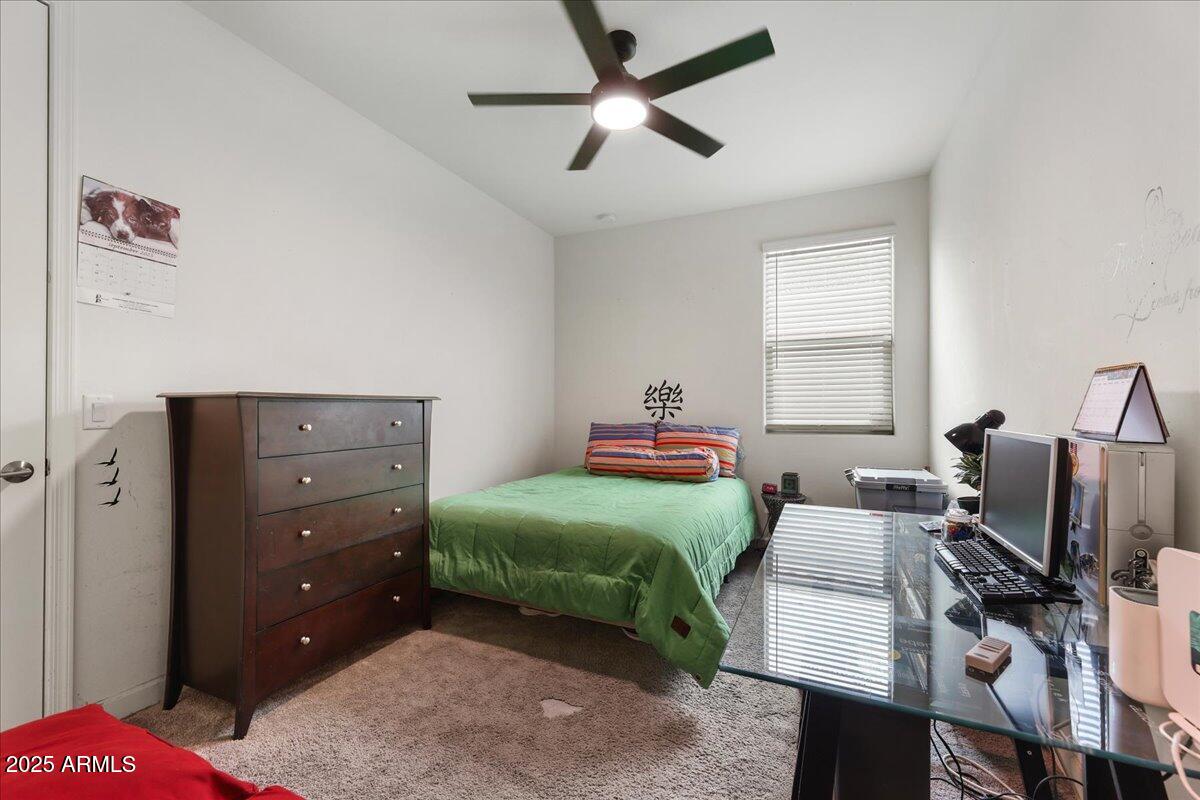 2745 West Pollack Street Phoenix, AZ 85041 - Photo 11 of 20 a bedroom with a bed and a television