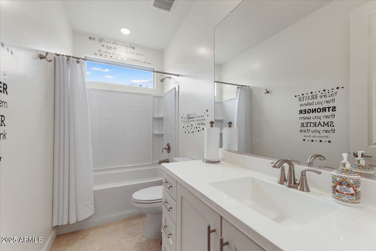 2745 West Pollack Street Phoenix, AZ 85041 - Photo 14 of 20 a bathroom with a granite countertop sink toilet a shower and a mirror