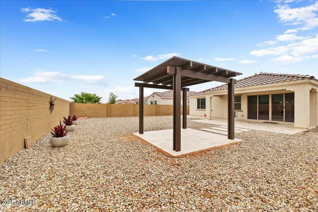 a view of a house with a backyard