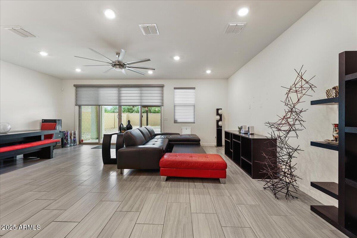 2745 West Pollack Street Phoenix, AZ 85041 - Photo 2 of 20 a living room with furniture a flat screen tv and a fireplace