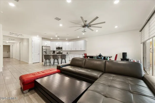 a living room with furniture and a view of kitchen