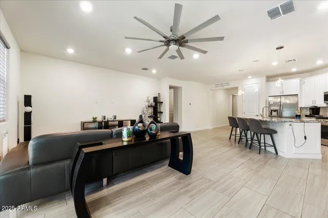 a living room with furniture and kitchen view