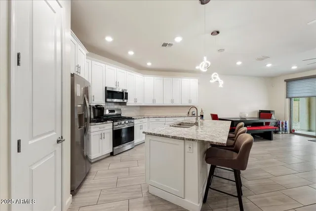 a kitchen with a sink stainless steel appliances and cabinets