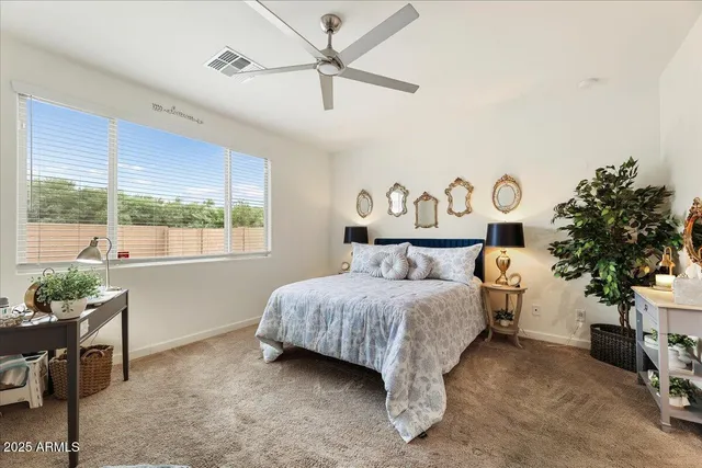 a bedroom with a bed table and a window