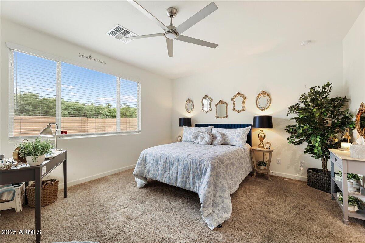 2745 West Pollack Street Phoenix, AZ 85041 - Photo 7 of 20 a bedroom with a bed table and a window