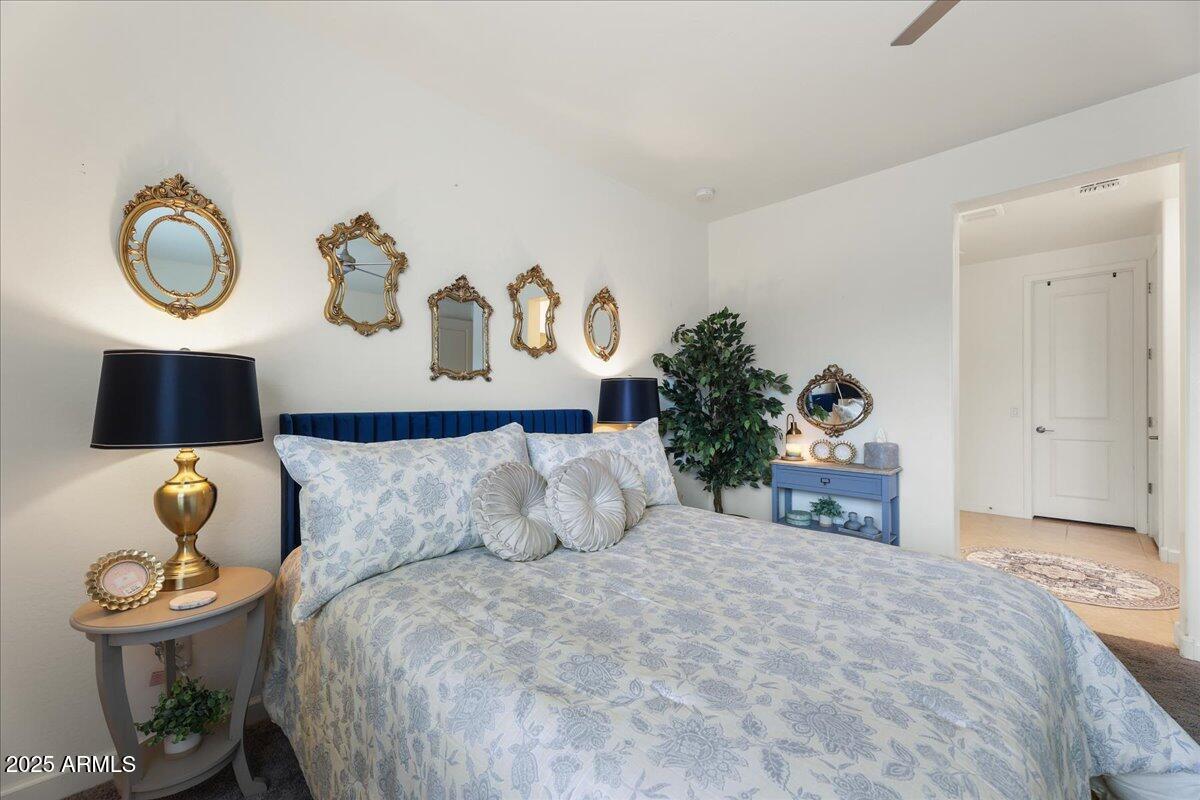 2745 West Pollack Street Phoenix, AZ 85041 - Photo 8 of 20 a bedroom with a bed and a potted plant