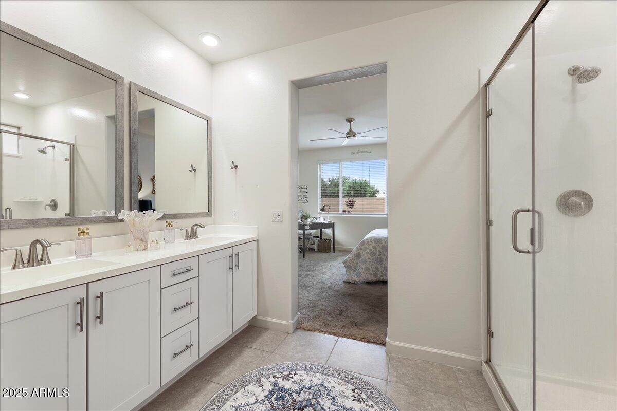 2745 West Pollack Street Phoenix, AZ 85041 - Photo 9 of 20 a spacious bathroom with a double vanity sink a mirror and shower