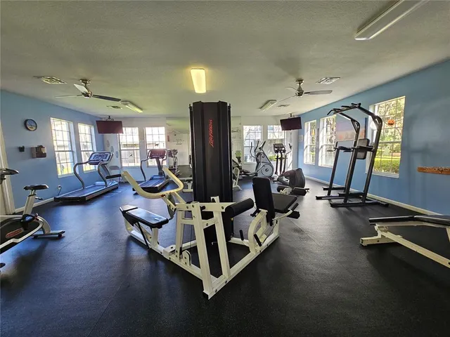 a room with gym equipment and a large window
