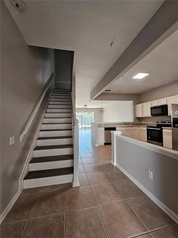 a kitchen with a cabinets and white appliances