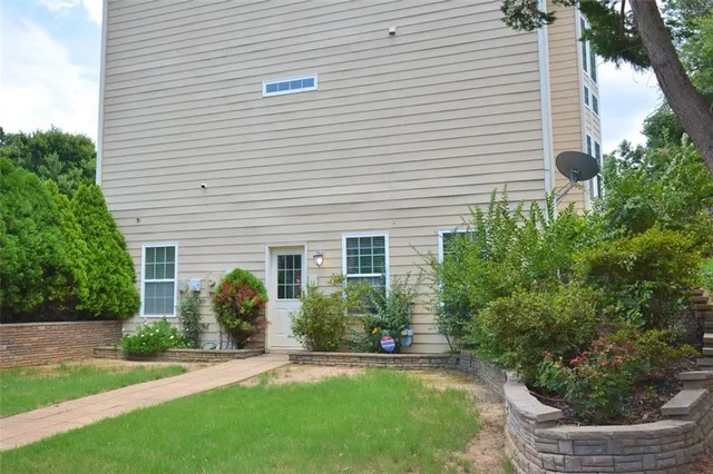 a view of a backyard with plants and trees