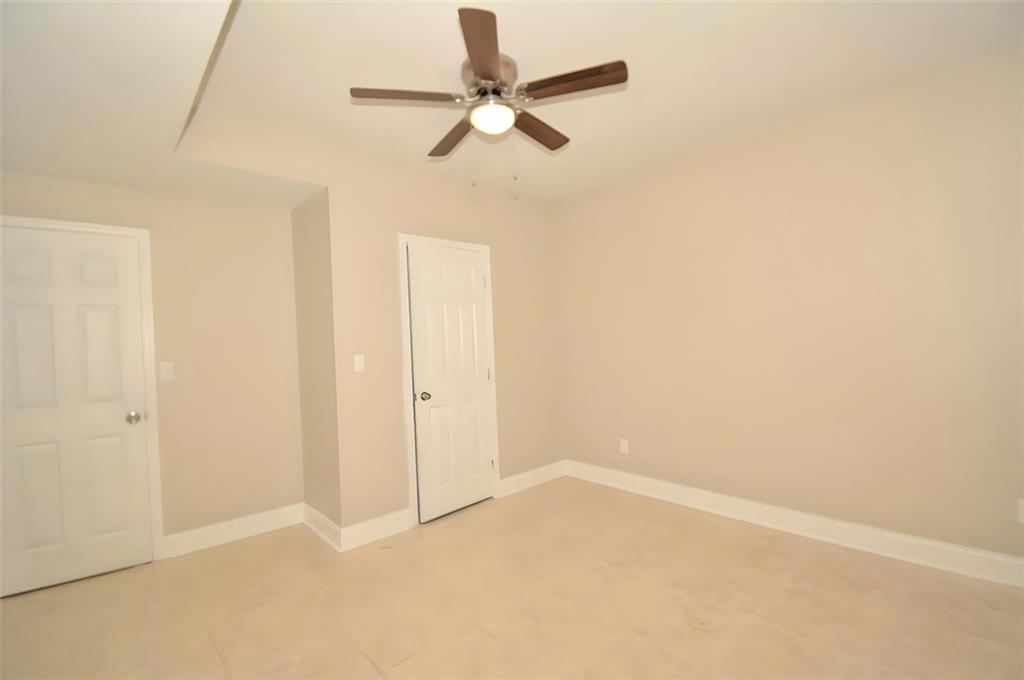 618 Tradwell Place Northeast, Unit BSMT Dacula, GA 30019 - Photo 11 of 20 an empty room with a ceiling fan and a window