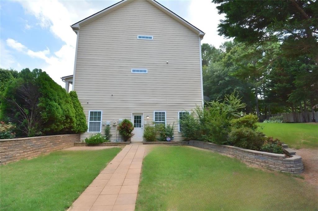 618 Tradwell Place Northeast, Unit BSMT Dacula, GA 30019 - Photo 18 of 20 a front view of house with yard and green space