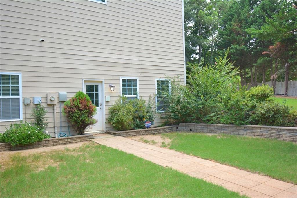 618 Tradwell Place Northeast, Unit BSMT Dacula, GA 30019 - Photo 20 of 20 a view of a backyard with plants and large trees