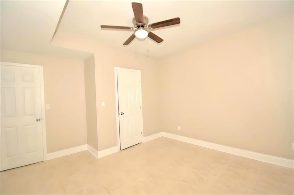 618 Tradwell Place Northeast, Unit BSMT Dacula, GA 30019 - Photo 10 of 20 an empty room with a ceiling fan and a window