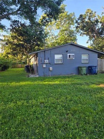 a brick building with a big yard