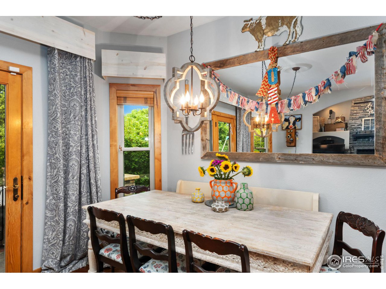 8265 Spinnaker Bay Drive Windsor, CO 80528 - Photo 12 of 40 a view of a dining room with furniture and chandelier
